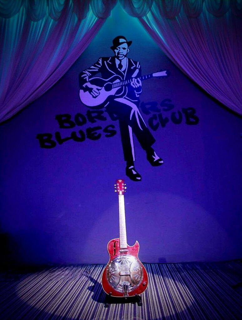 How Askew red dobro on stage in the spotlight at the Border Blues Club